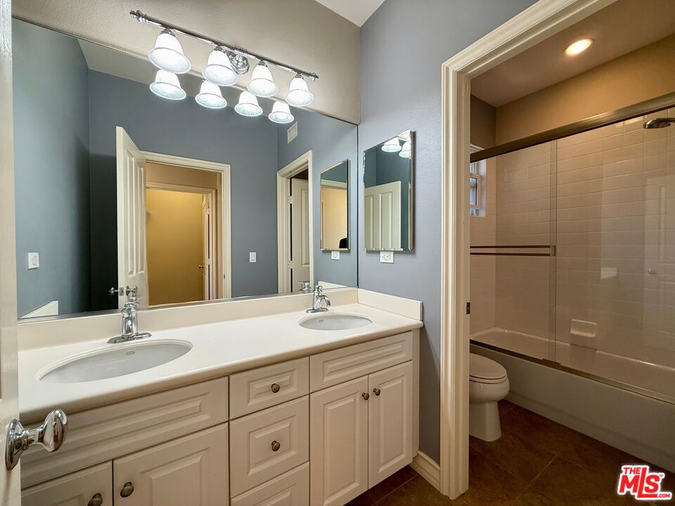 68 Cornflower Irvine, CA 92620 - Photo 16 of 21 a bathroom with a double vanity sink toilet and shower