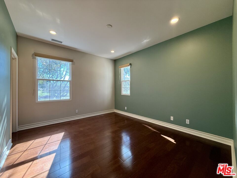 68 Cornflower Irvine, CA 92620 - Photo 17 of 21 an empty room with wooden floor and windows