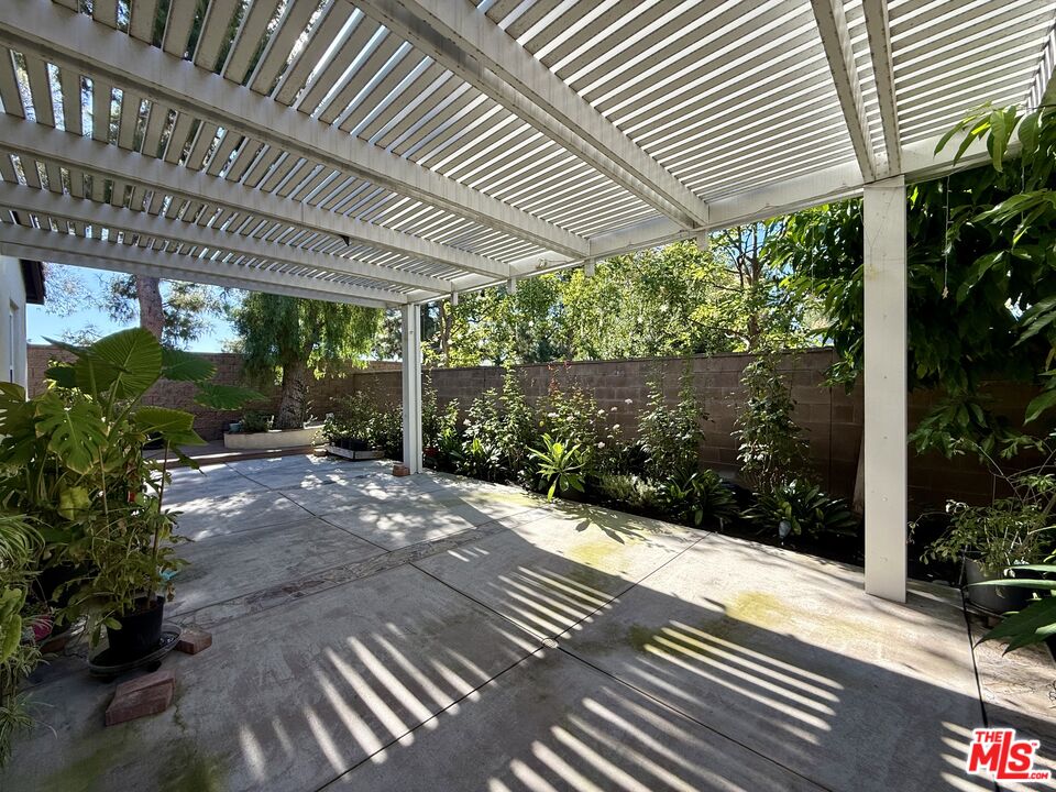 68 Cornflower Irvine, CA 92620 - Photo 20 of 21 a view of a patio with table and chairs under an umbrella with plants