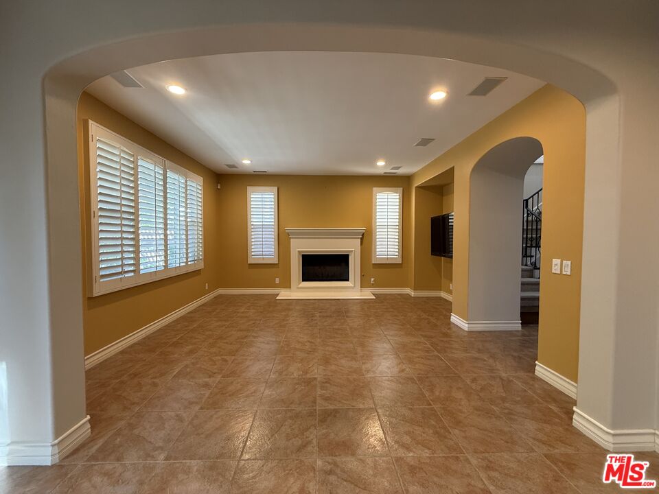 68 Cornflower Irvine, CA 92620 - Photo 3 of 21 a view of an empty room with a fireplace and a window