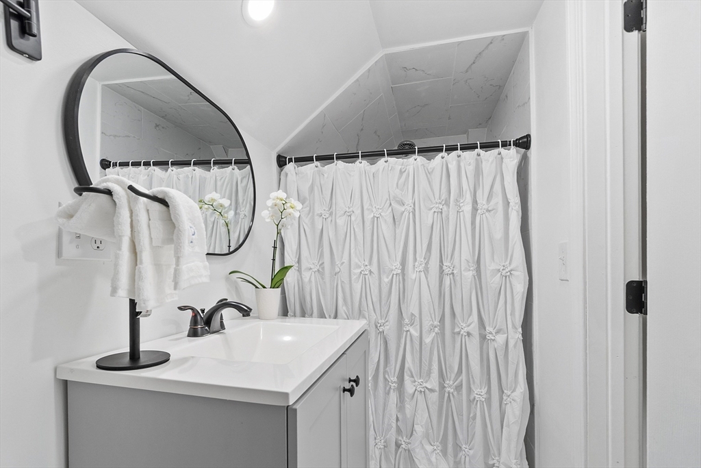 10 Burnham Road Andover, MA 01810 - Photo 13 of 25 a bathroom with a sink and a mirror
