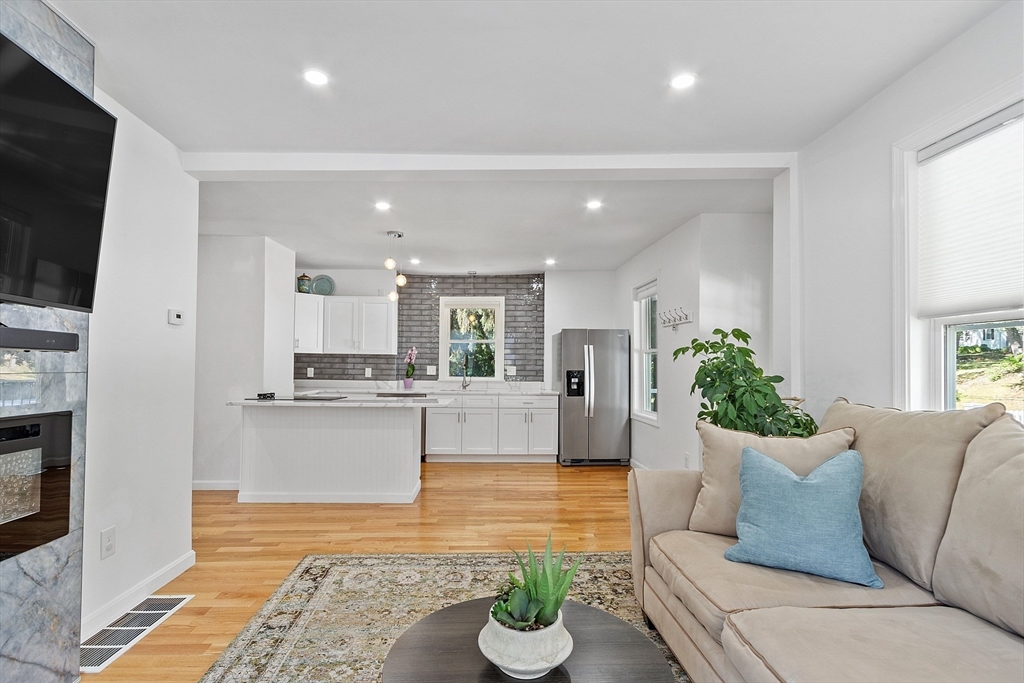 10 Burnham Road Andover, MA 01810 - Photo 5 of 25 a living room with kitchen island furniture and a view of kitchen