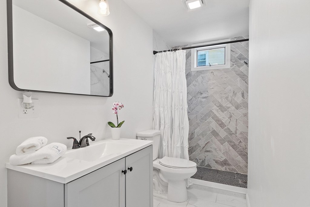 10 Burnham Road Andover, MA 01810 - Photo 7 of 25 a bathroom with a sink mirror and toilet
