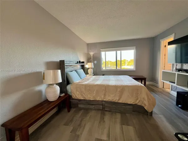 a spacious bedroom with a bed and window