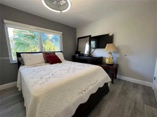 a bedroom with bed and window