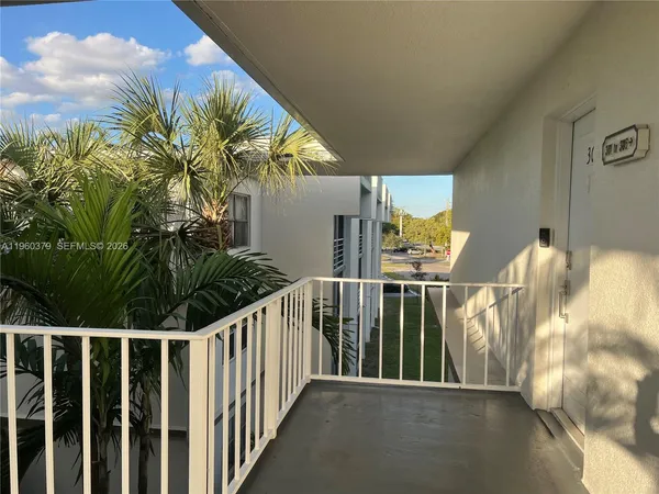 a view of balcony with wooden floor and fence