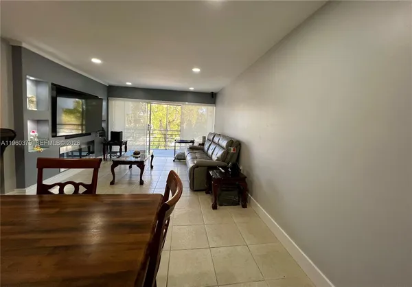 a lobby with furniture and a flat screen tv