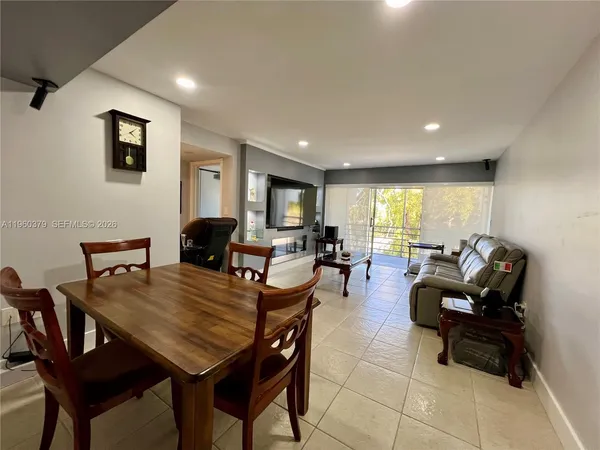 a living room with furniture a rug and a flat screen tv