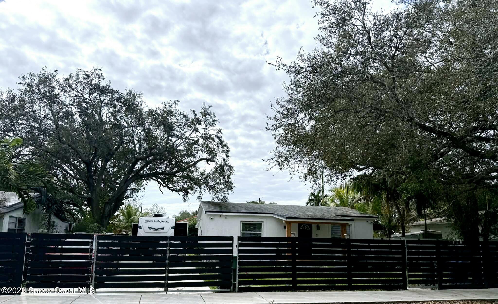 1340 Northwest 112th Street Miami, FL 33167 - Photo 1 of 20 a front view of a house with garden
