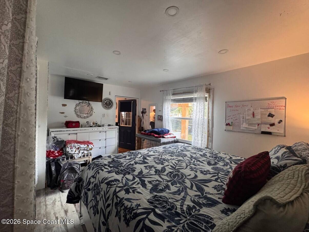 1340 Northwest 112th Street Miami, FL 33167 - Photo 14 of 20 a bed room with a bed and a tv