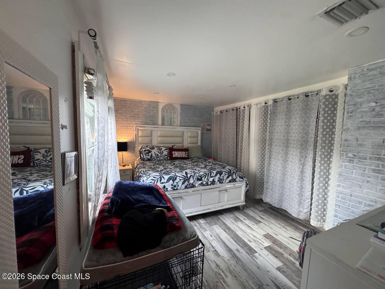 1340 Northwest 112th Street Miami, FL 33167 - Photo 16 of 20 a bedroom with a bed and a mirror