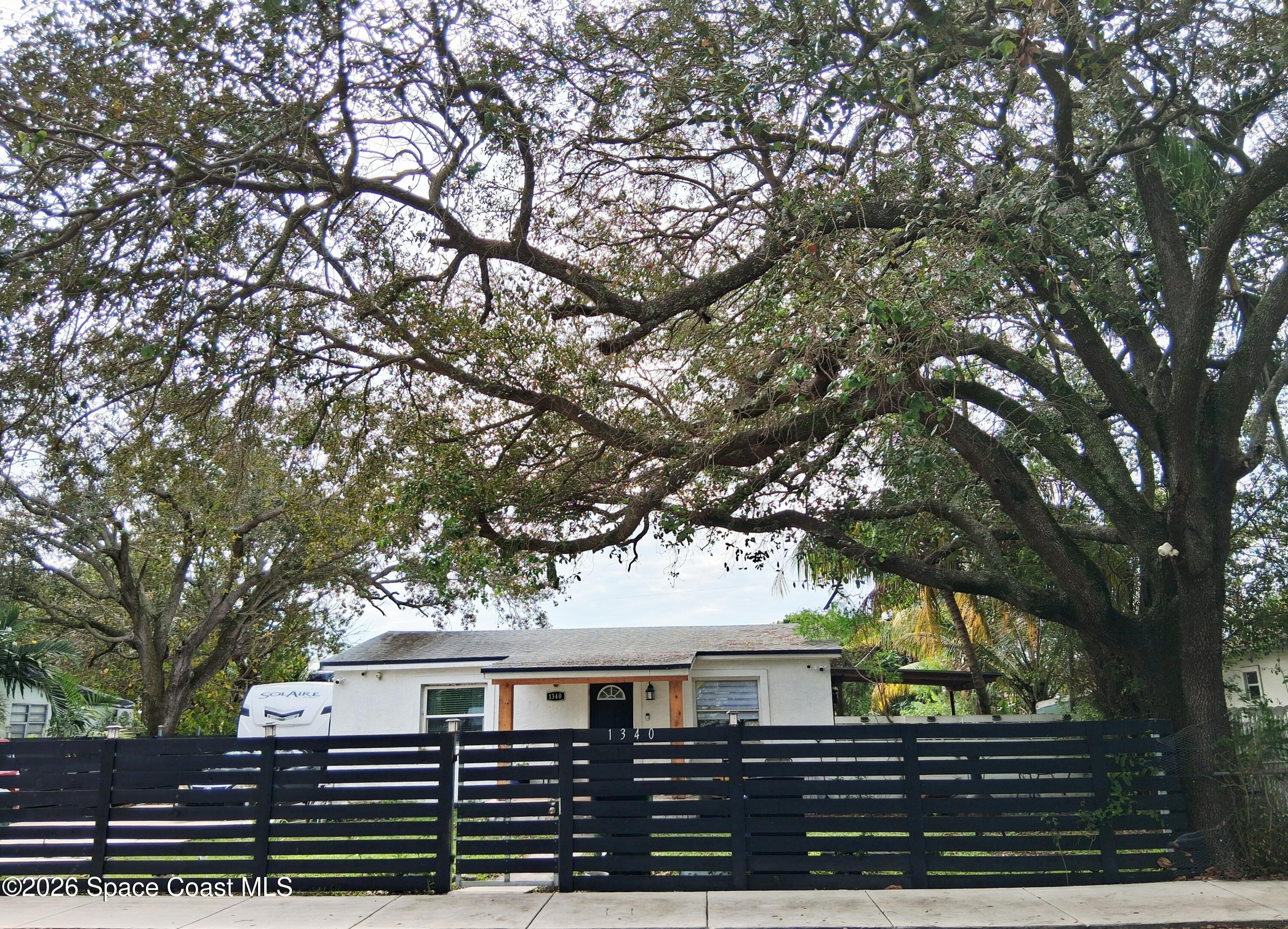 1340 Northwest 112th Street Miami, FL 33167 - Photo 2 of 20 a view of house with a tree in the background