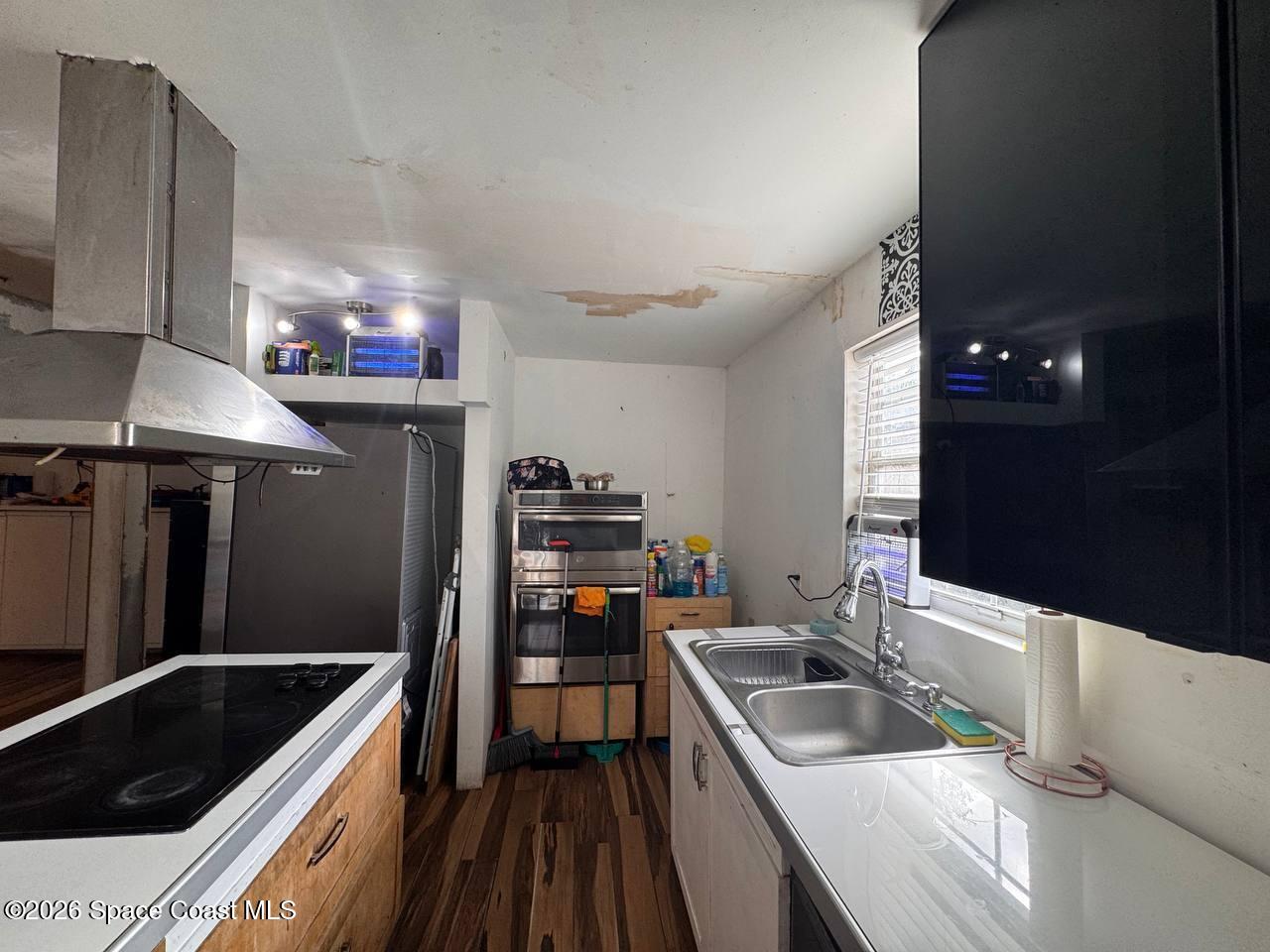 1340 Northwest 112th Street Miami, FL 33167 - Photo 6 of 20 a kitchen with granite countertop a sink and cabinets