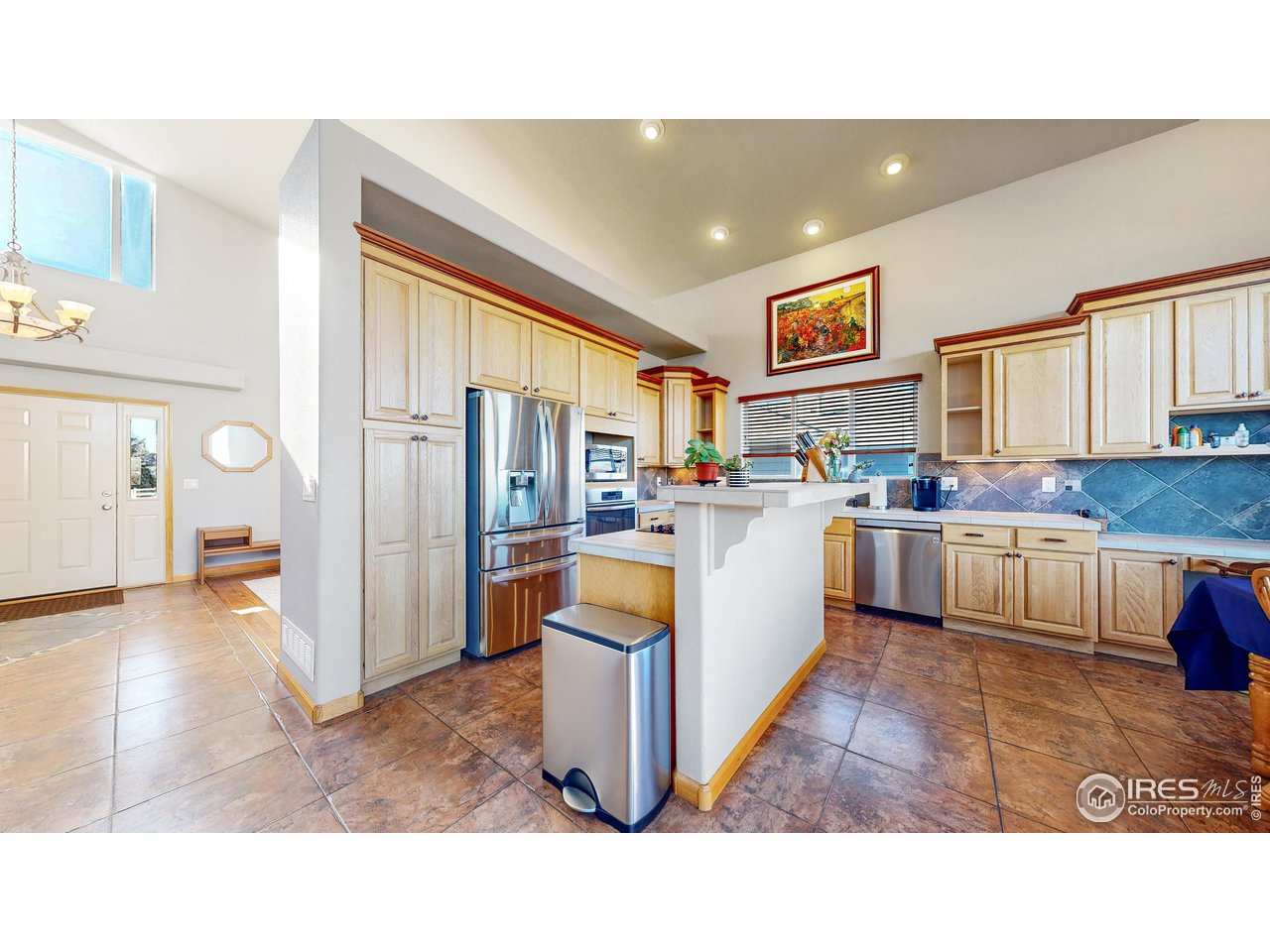 8368 Castaway Drive Windsor, CO 80528 - Photo 10 of 40 Spacious kitchen with island and loads of custom Schroll cabinetry with pull outs and counter space