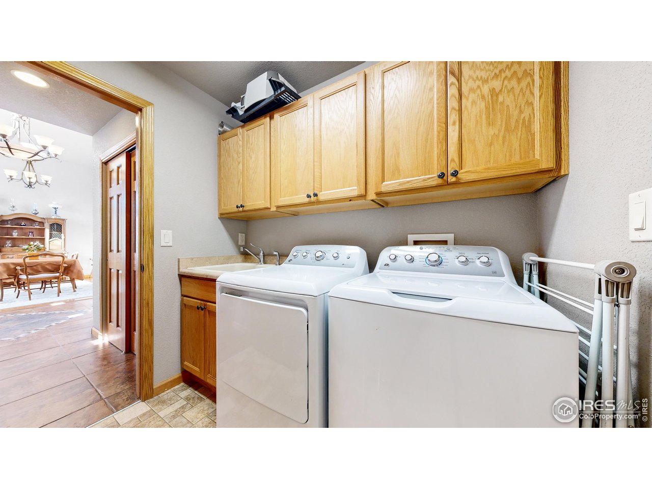 8368 Castaway Drive Windsor, CO 80528 - Photo 13 of 40 Main level laundry with sink basin and nice cabinetry conveniently located for everyone in the home!