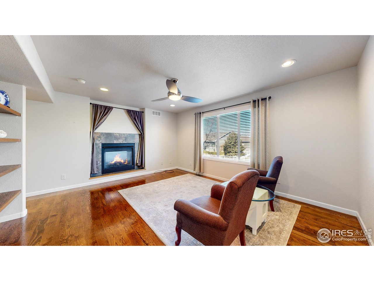 8368 Castaway Drive Windsor, CO 80528 - Photo 15 of 40 Double sided fireplace and loads of built in shelving to enhance this great living space