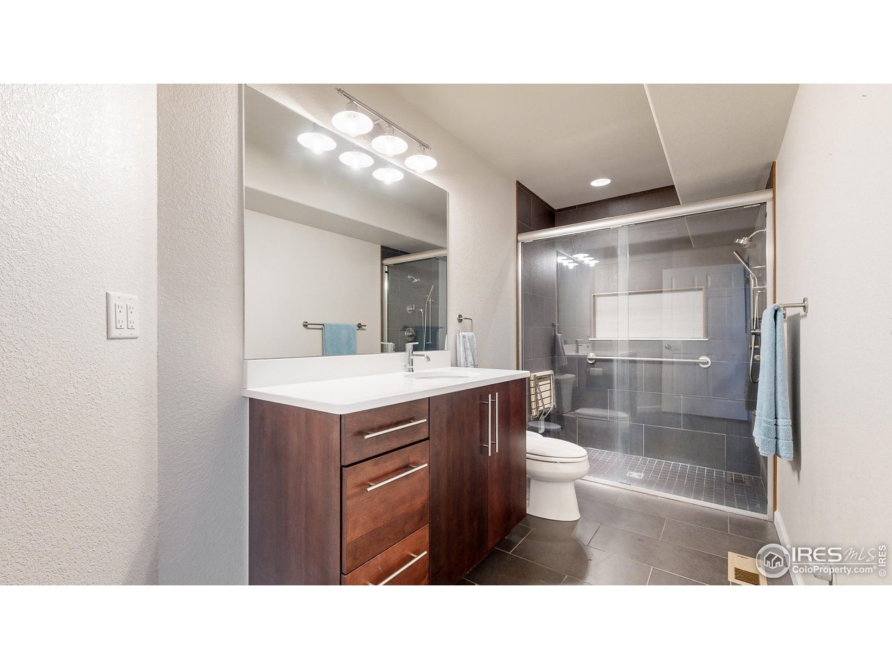 8368 Castaway Drive Windsor, CO 80528 - Photo 18 of 40 Gorgeous attached en-suite bathroom on main level with zero entry tiled shower for easy and accessible access and recently done!