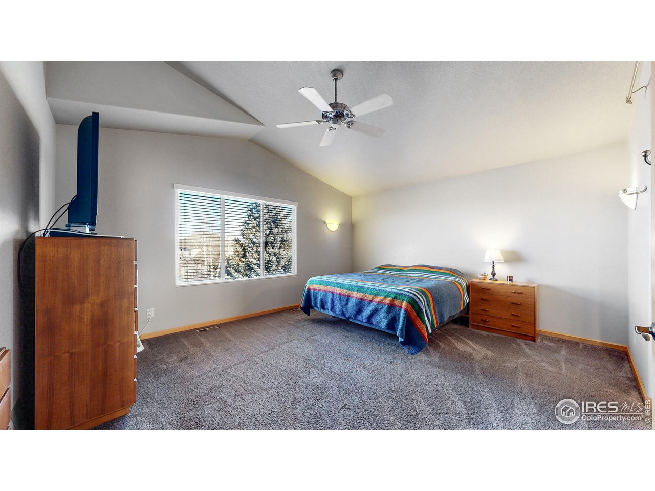 8368 Castaway Drive Windsor, CO 80528 - Photo 19 of 40 Huge upstairs primary ensuite bedroom with high vaulted ceilings and mountain views! NEW CARPET ON ORDER!