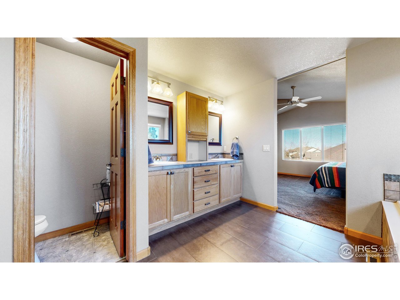 8368 Castaway Drive Windsor, CO 80528 - Photo 22 of 40 Updated Primary en-suite 5 pc. bathroom: double vanity, separate water closet, beautiful tile flooring and walk in closet