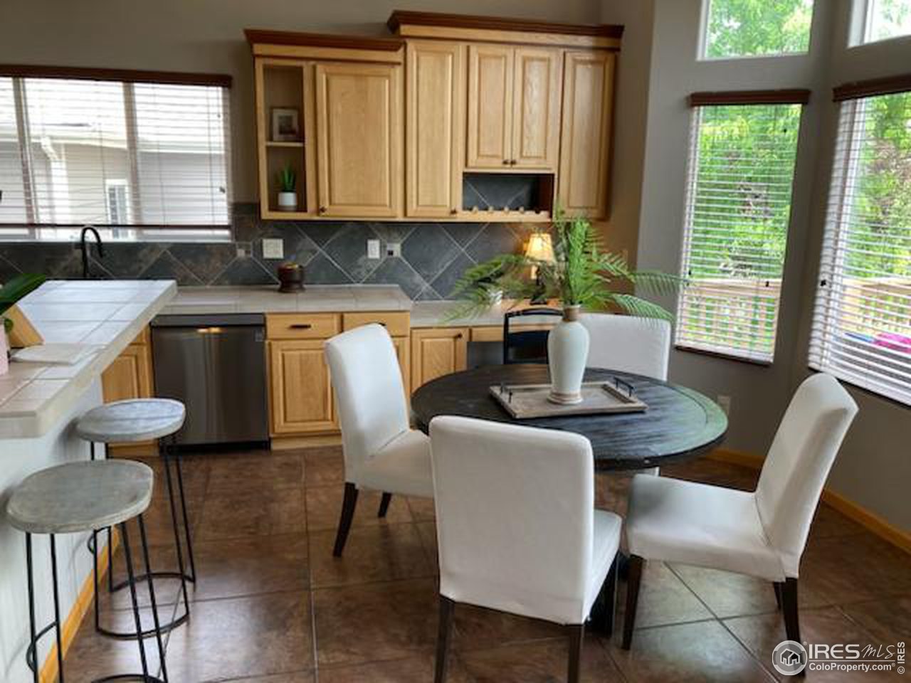 8368 Castaway Drive Windsor, CO 80528 - Photo 8 of 40 Spacious eat in kitchen and tech center space (could easily be converted to additional pantry space) with great access to patio area