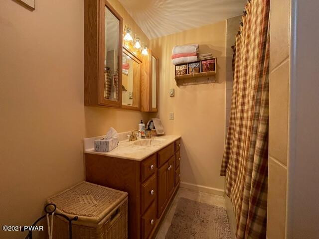 259 High Ridge Road Dingmans Ferry, PA 18328 - Photo 19 of 19 a bathroom with a sink a vanity and a mirror