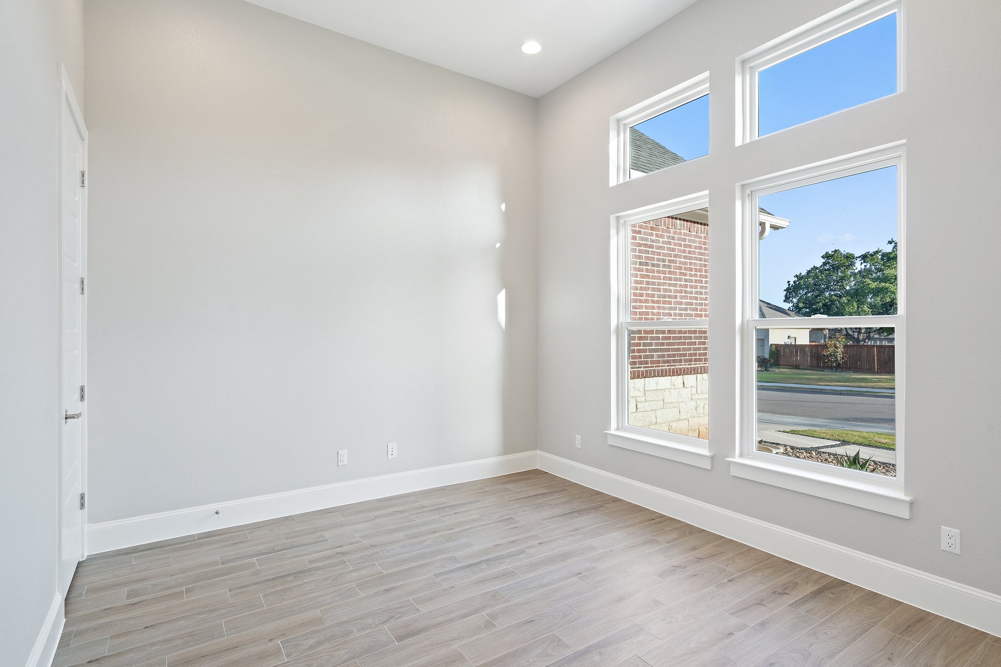 112 Axis Loop Georgetown, TX 78628 - Photo 3 of 39 an empty room with wooden floor and windows