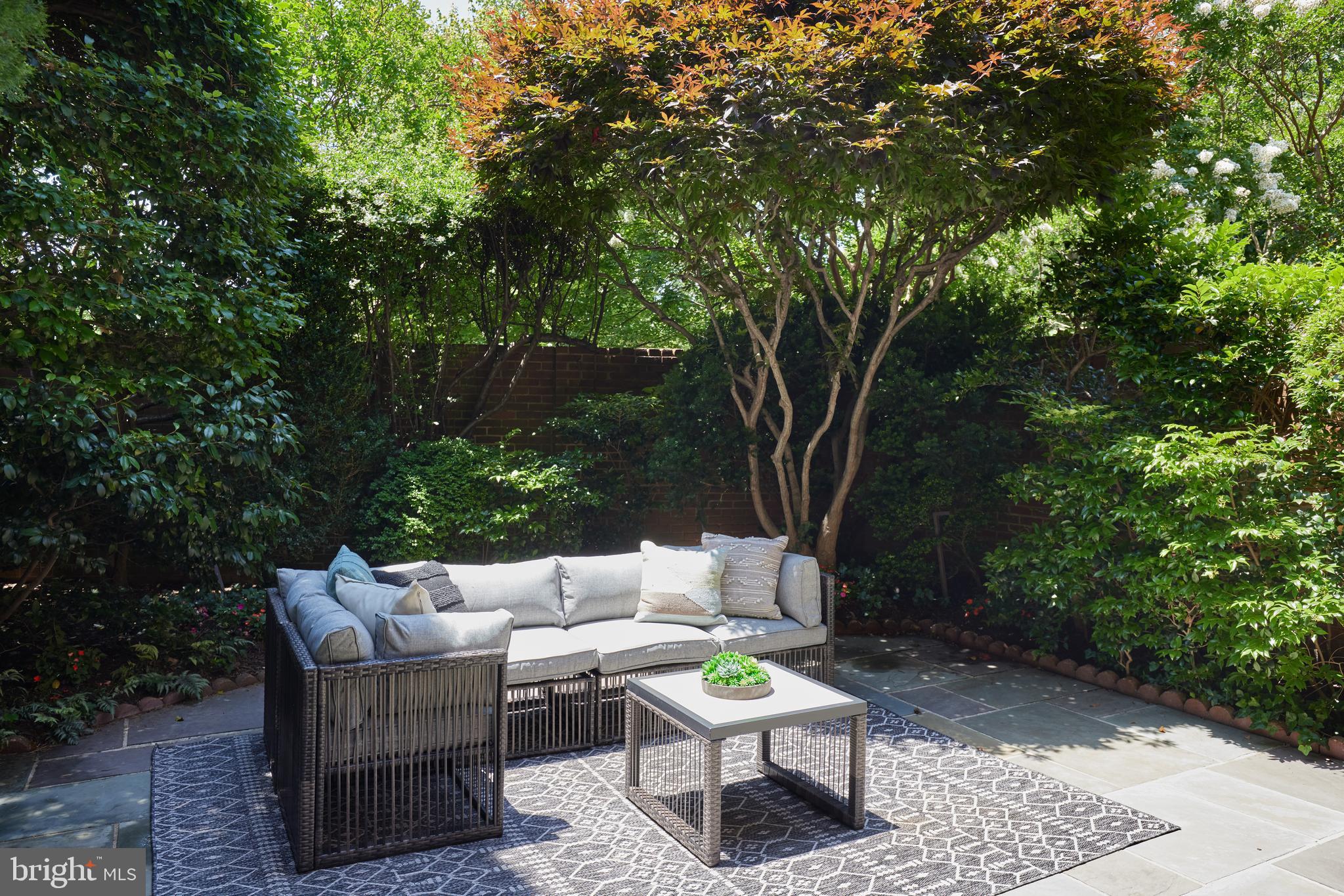 1802 Kalorama Square, Unit 16 Washington, DC 20008 - Photo 15 of 58 a backyard of a house with a table and chairs