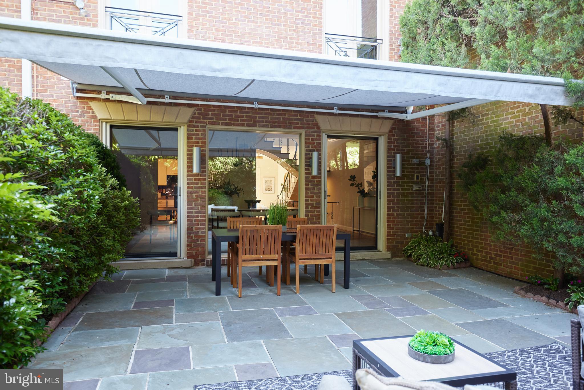 1802 Kalorama Square, Unit 16 Washington, DC 20008 - Photo 17 of 58 a view of a patio with table and chairs potted plants with wooden fence