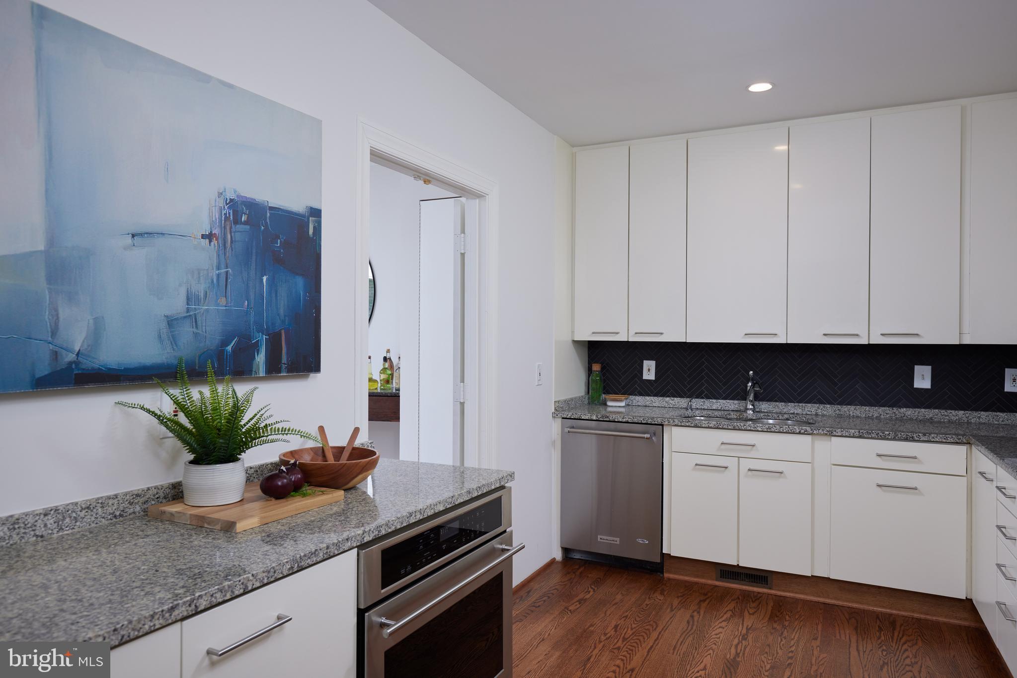 1802 Kalorama Square, Unit 16 Washington, DC 20008 - Photo 20 of 58 a kitchen with granite countertop a sink a stove and cabinets