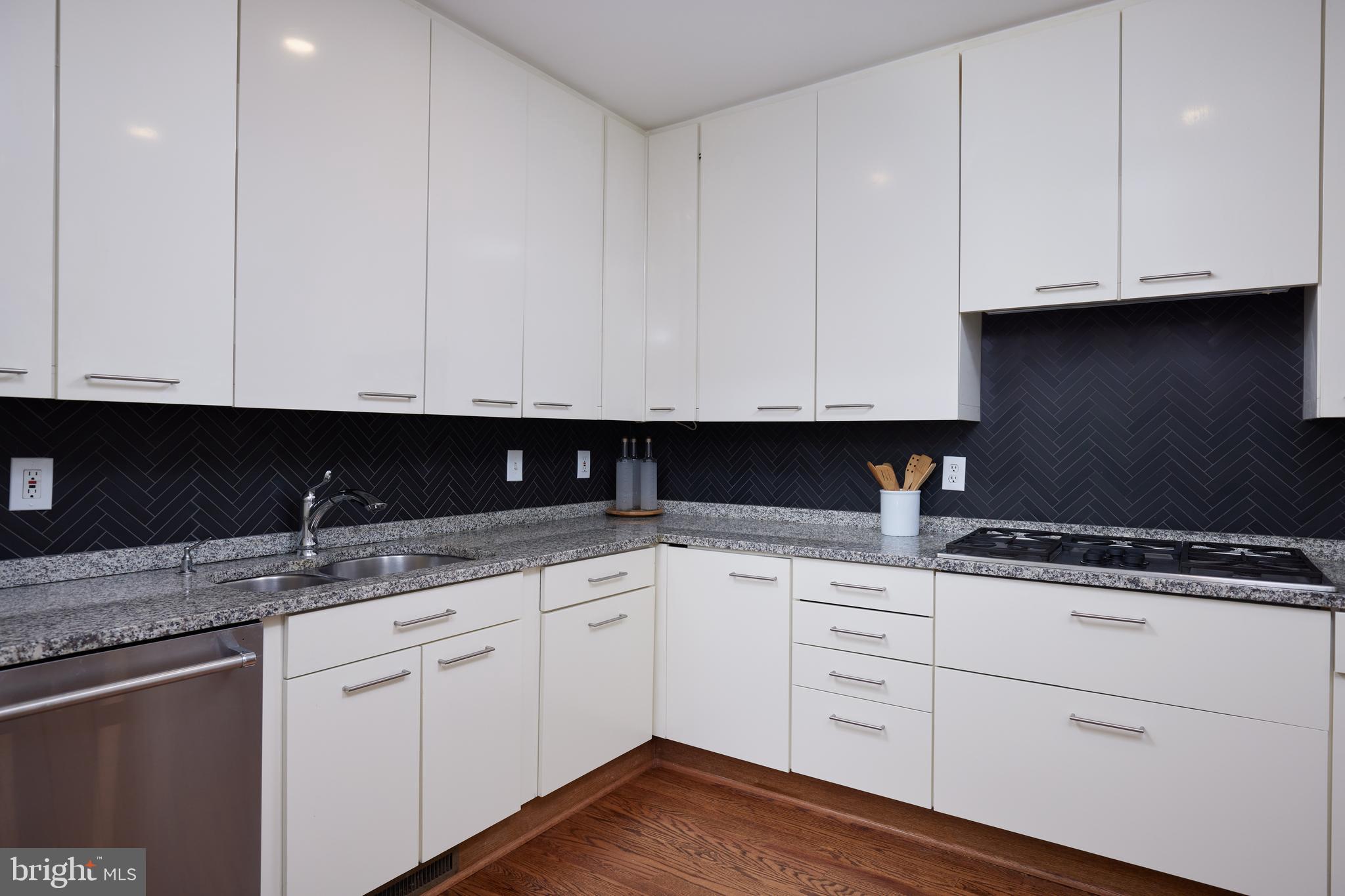 1802 Kalorama Square, Unit 16 Washington, DC 20008 - Photo 21 of 58 a kitchen with granite countertop white cabinets and a sink