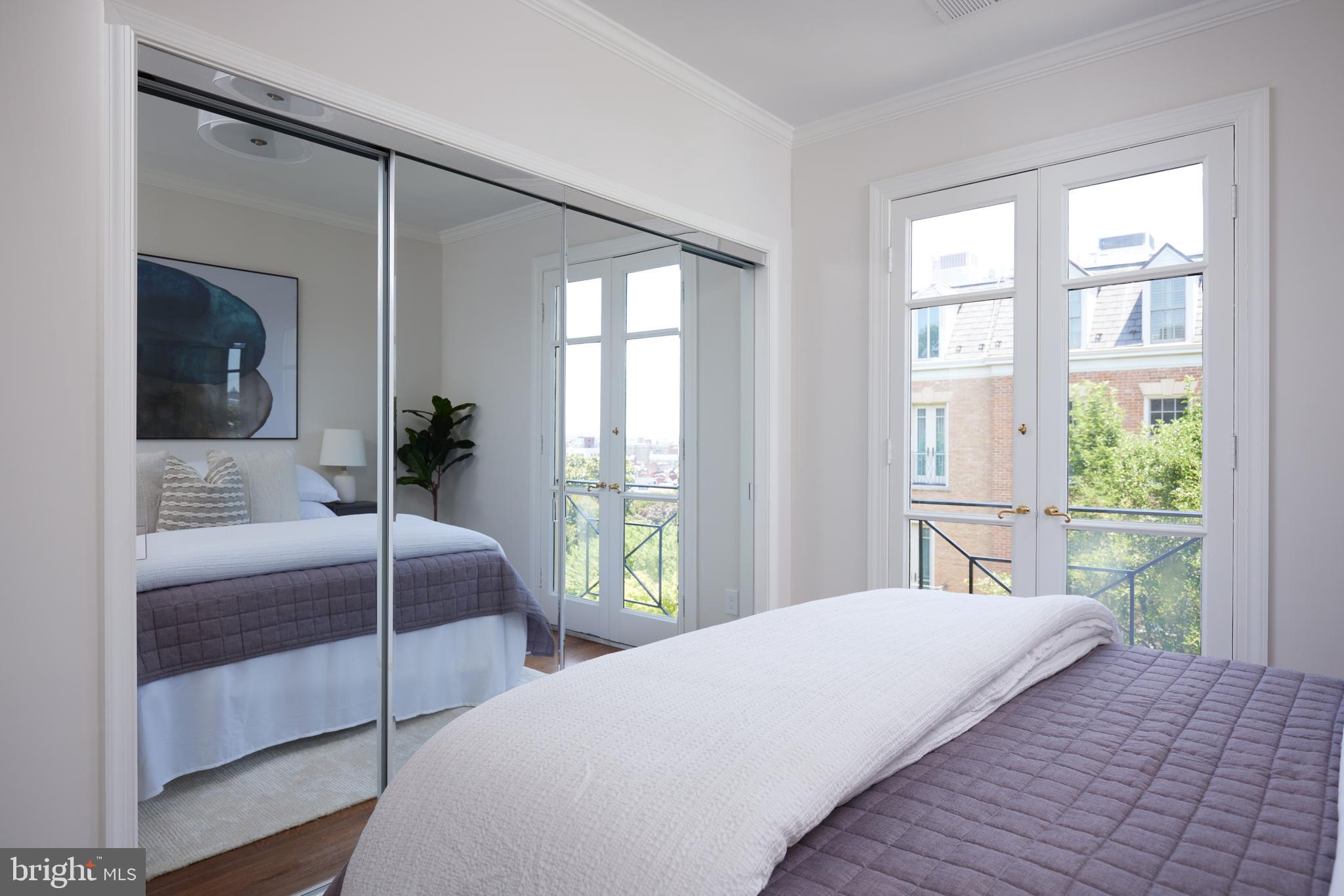 1802 Kalorama Square, Unit 16 Washington, DC 20008 - Photo 41 of 58 a bedroom with a large bed and a large window