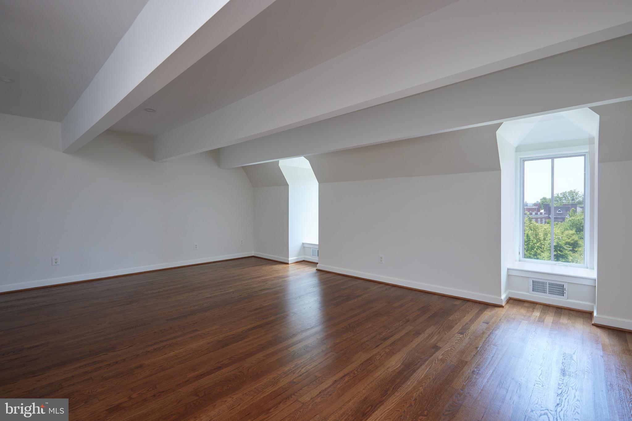 1802 Kalorama Square, Unit 16 Washington, DC 20008 - Photo 44 of 58 a view of an empty room with wooden floor and window