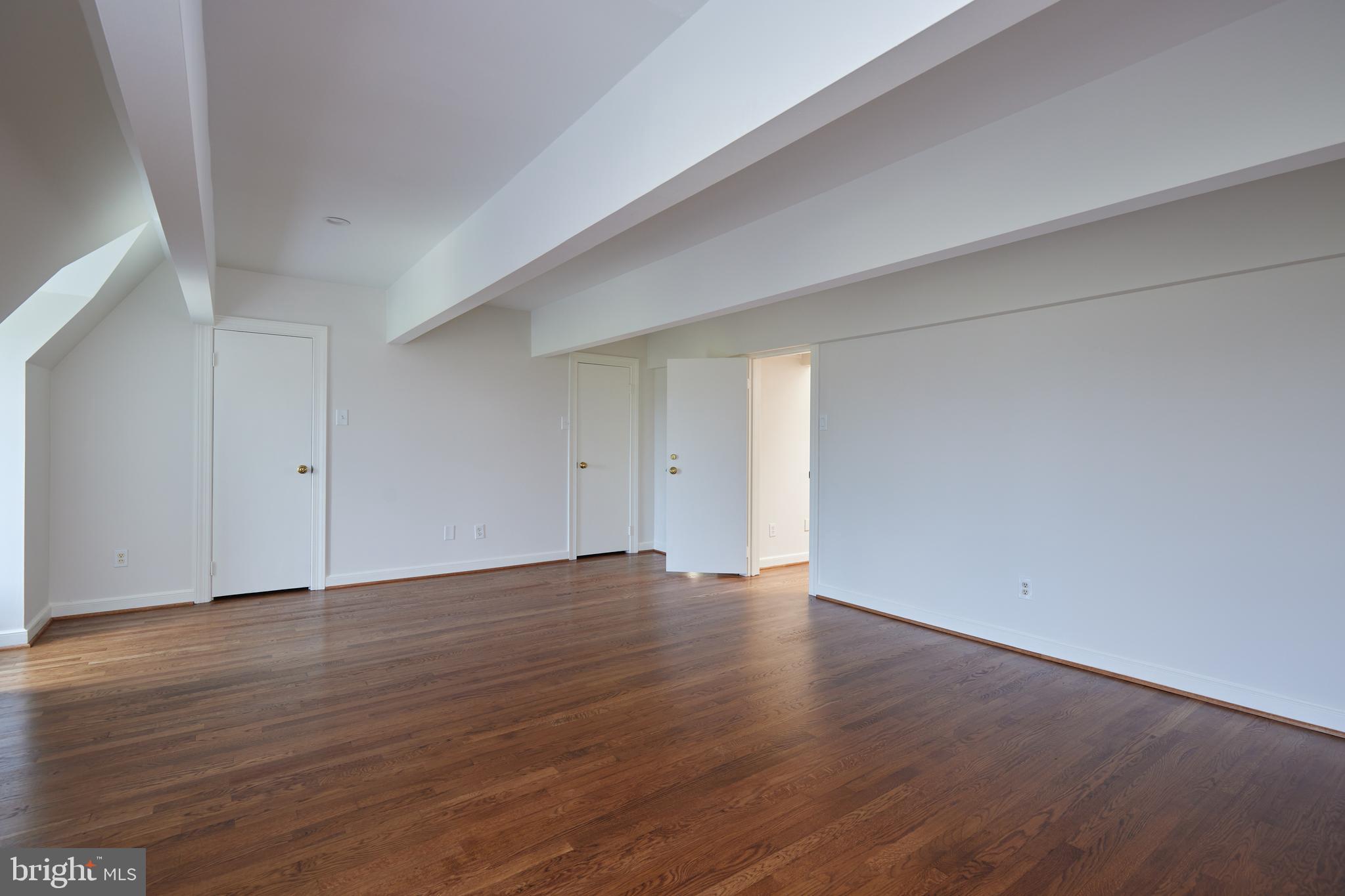 1802 Kalorama Square, Unit 16 Washington, DC 20008 - Photo 45 of 58 a view of an empty room with wooden floor