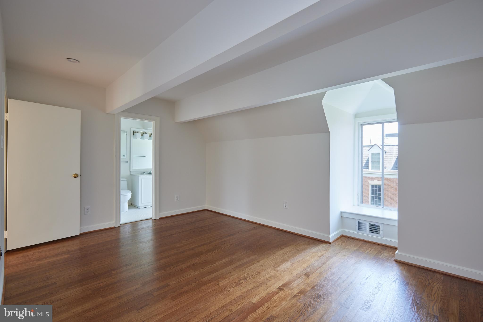 1802 Kalorama Square, Unit 16 Washington, DC 20008 - Photo 47 of 58 an empty room with wooden floor and windows