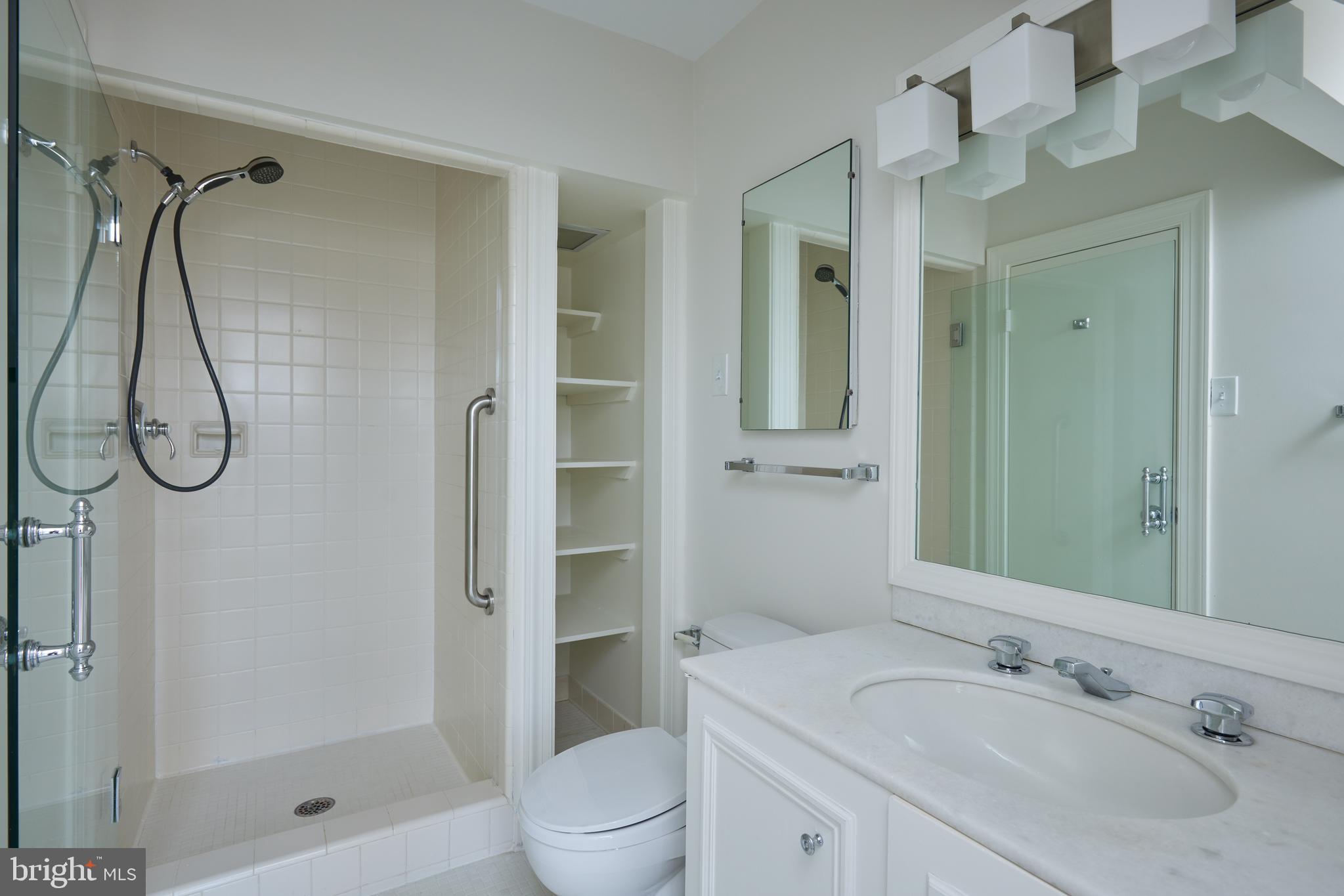 1802 Kalorama Square, Unit 16 Washington, DC 20008 - Photo 48 of 58 a bathroom with a sink vanity mirror and shower