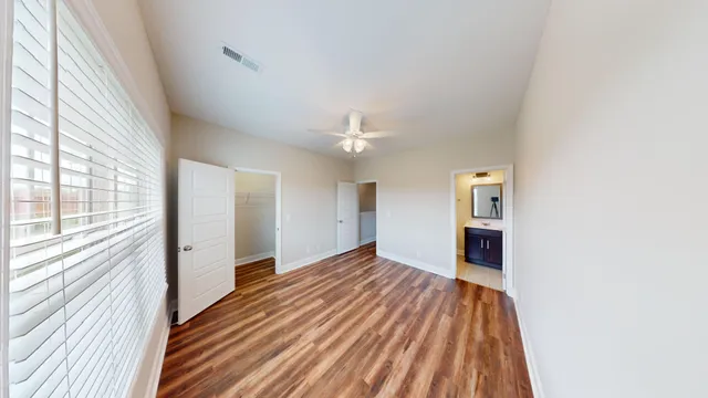 a spacious bathroom with a granite countertop sink toilet and shower