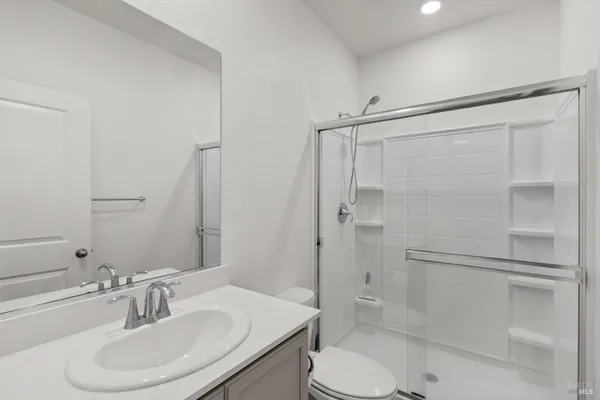 a bathroom with a sink toilet and shower