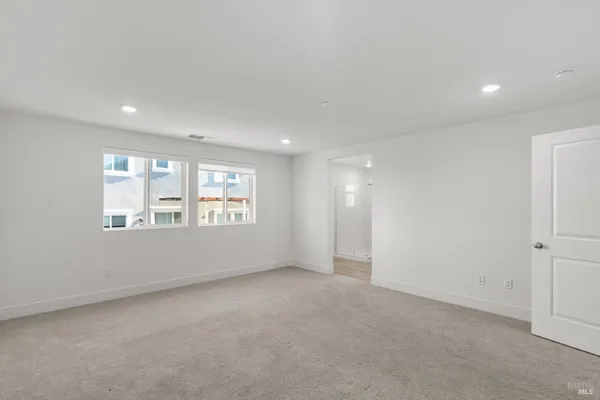 a spacious bathroom with a shower sink and mirror