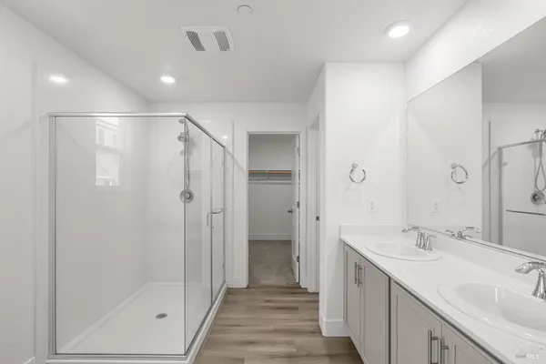 a bathroom with a double vanity sink and a toilet