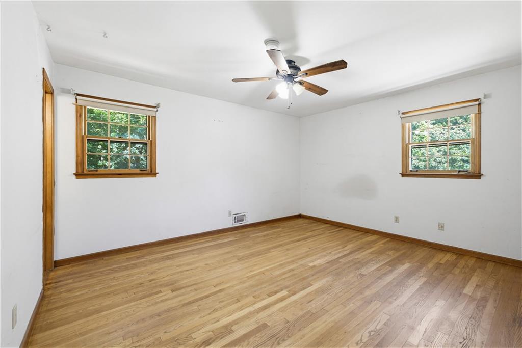 4188 Cedar Valley Lane Conley, GA 30288 - Photo 20 of 28 a view of an empty room with wooden floor and a window