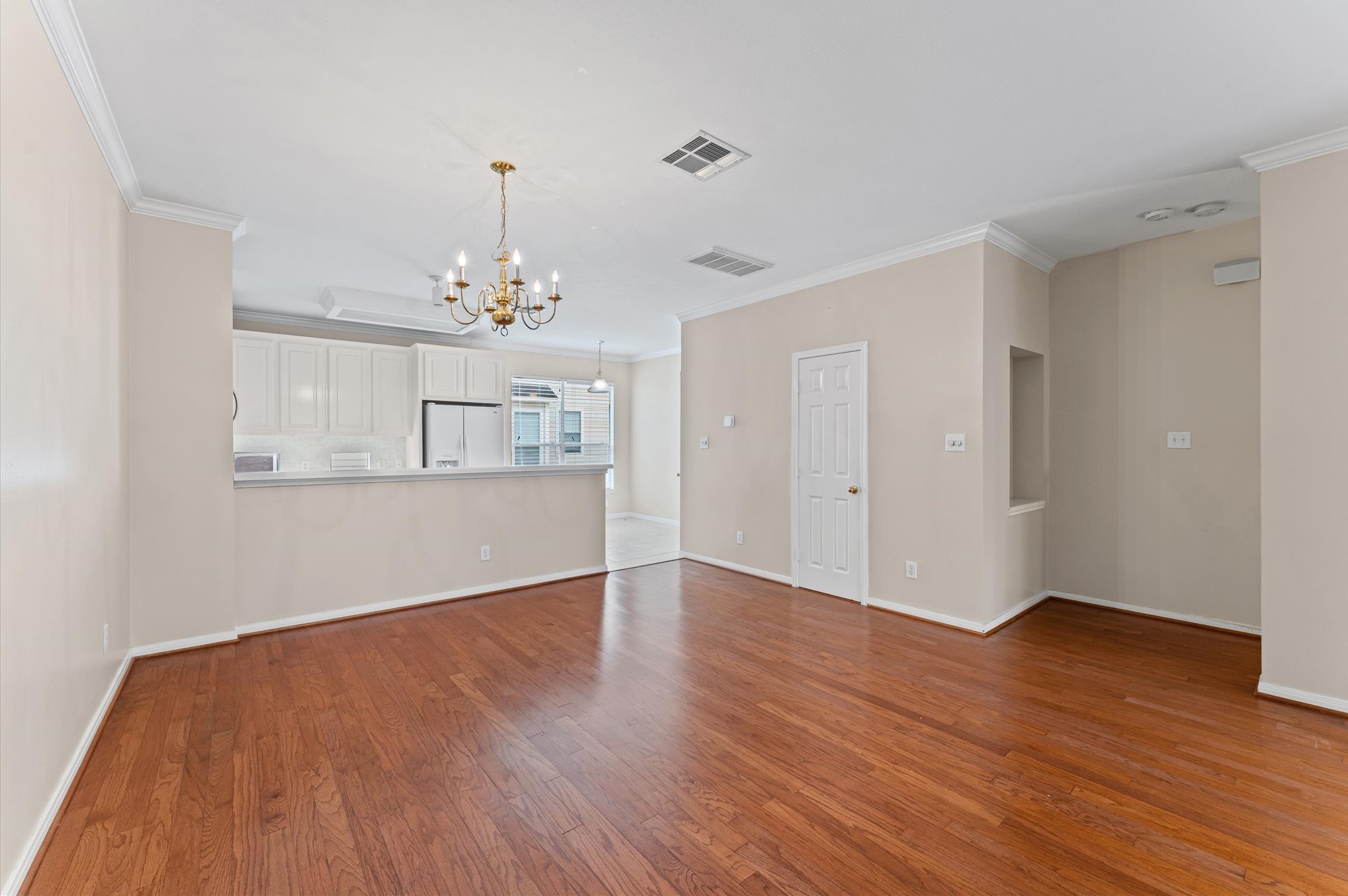 2905 Crawford Street Houston, TX 77004 - Photo 11 of 28 a view of a room with wooden floor and chandelier