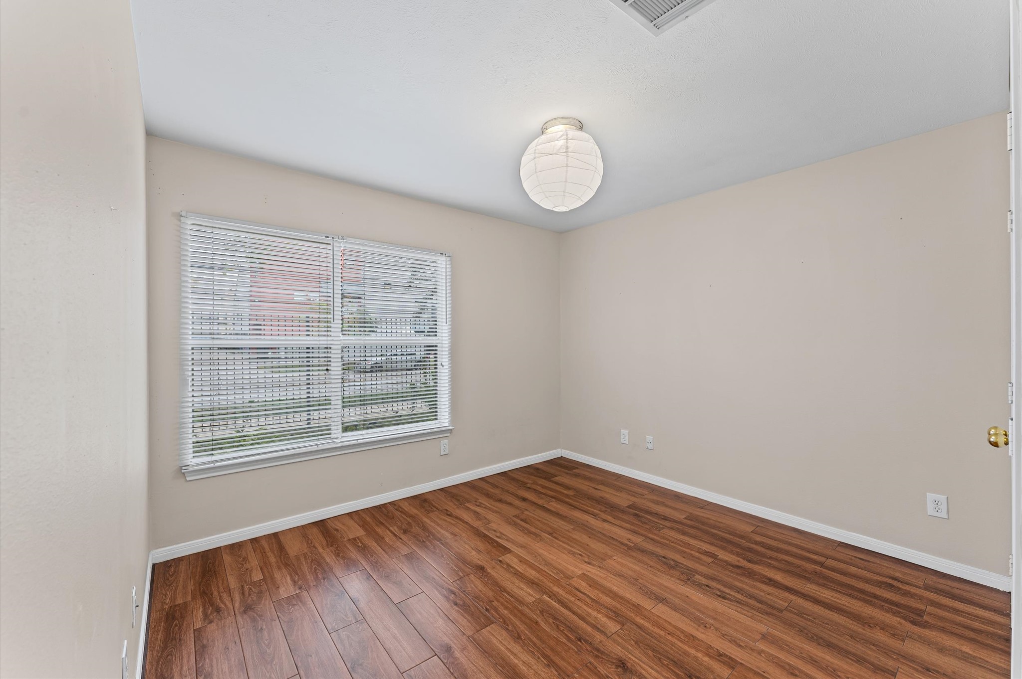 2905 Crawford Street Houston, TX 77004 - Photo 13 of 28 a view of an empty room with wooden floor and a window
