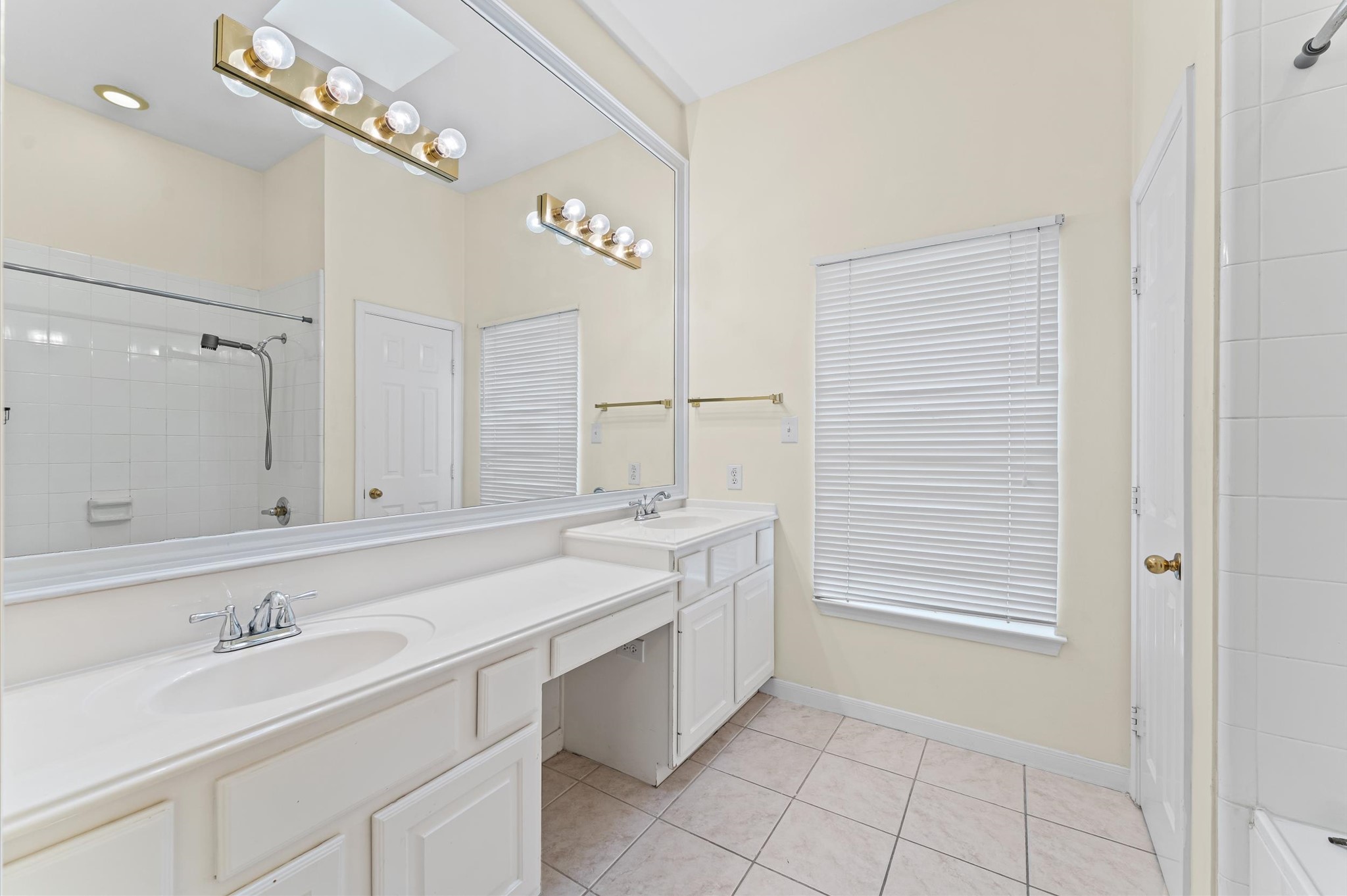 2905 Crawford Street Houston, TX 77004 - Photo 23 of 28 a bathroom with a sink a vanity and a mirror