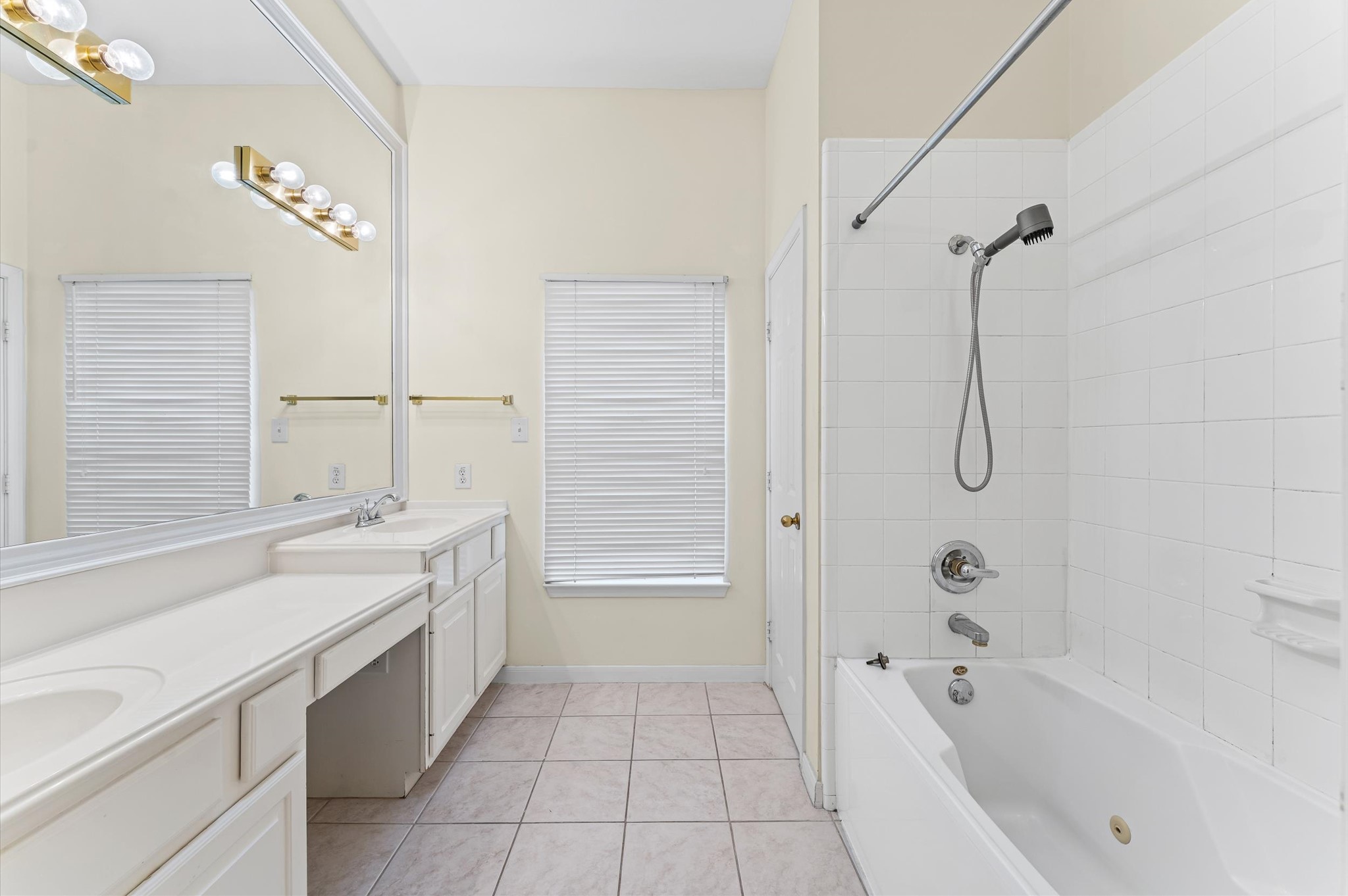 2905 Crawford Street Houston, TX 77004 - Photo 24 of 28 a bathroom with a tub a sink and a mirror
