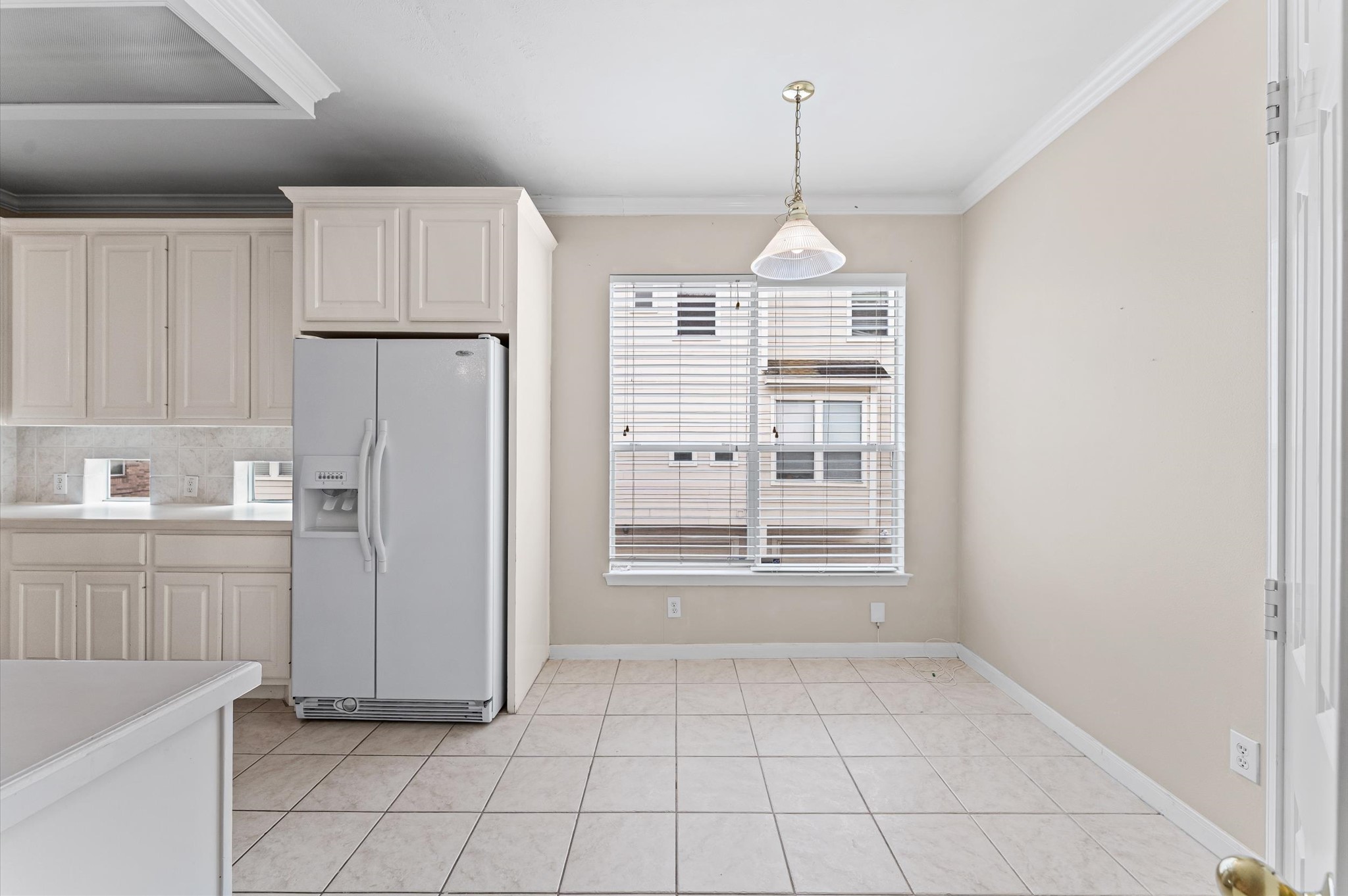 2905 Crawford Street Houston, TX 77004 - Photo 5 of 28 a kitchen with kitchen island white cabinets and refrigerator