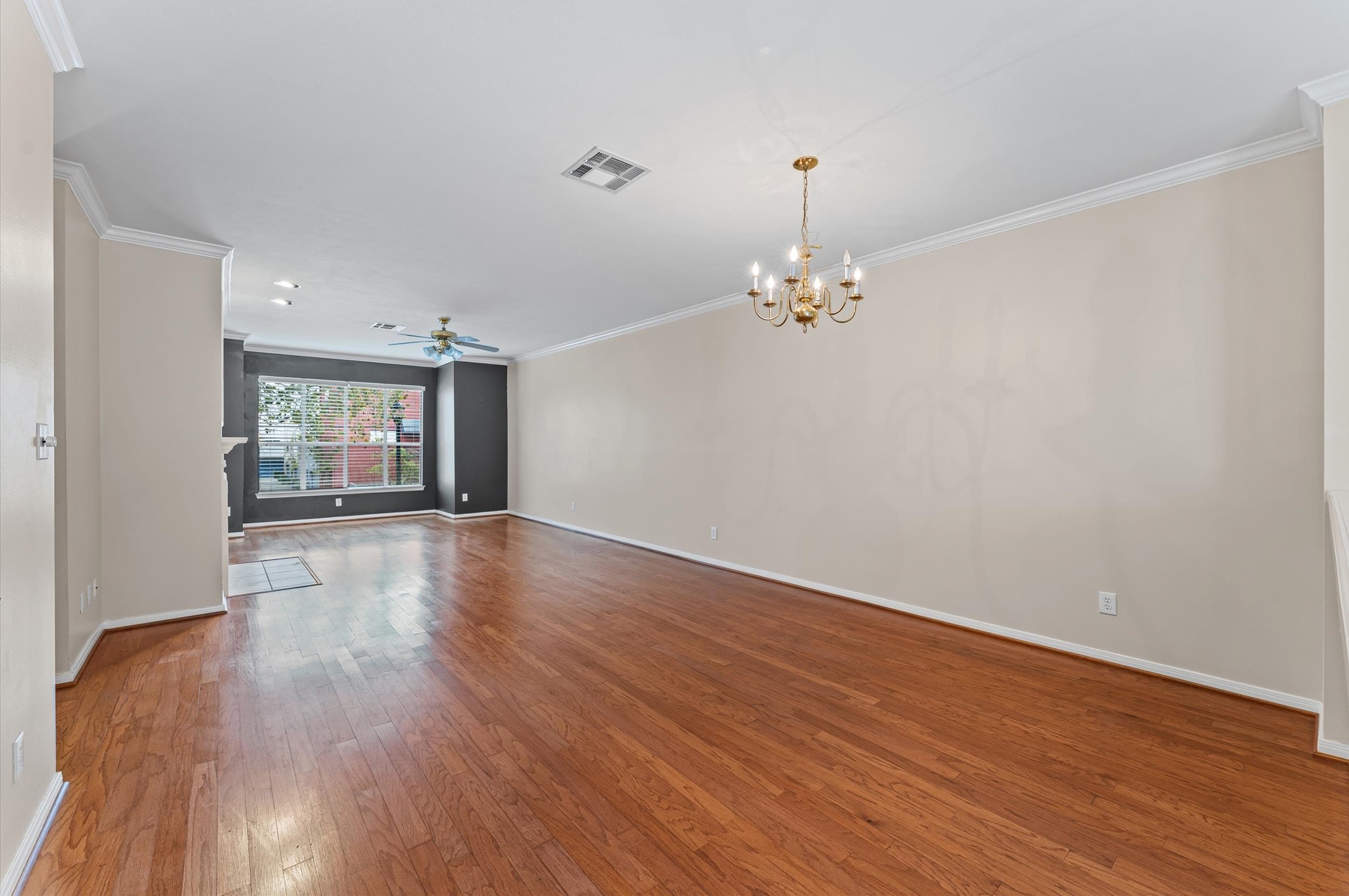 2905 Crawford Street Houston, TX 77004 - Photo 9 of 28 a view of an empty room with wooden floor and a window
