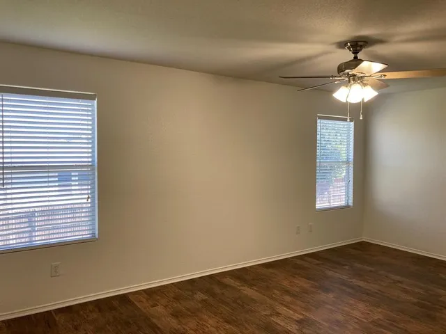 a view of a livingroom with a chandelier fan and a window