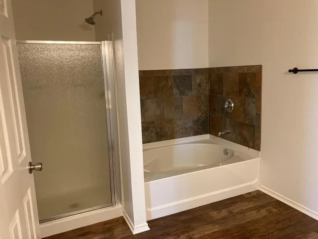 a bath tub sitting next to a shower