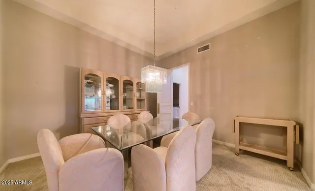 a dining room with furniture and a chandelier