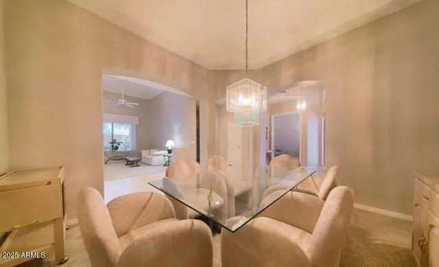 a living room with furniture a chandelier and a large mirror
